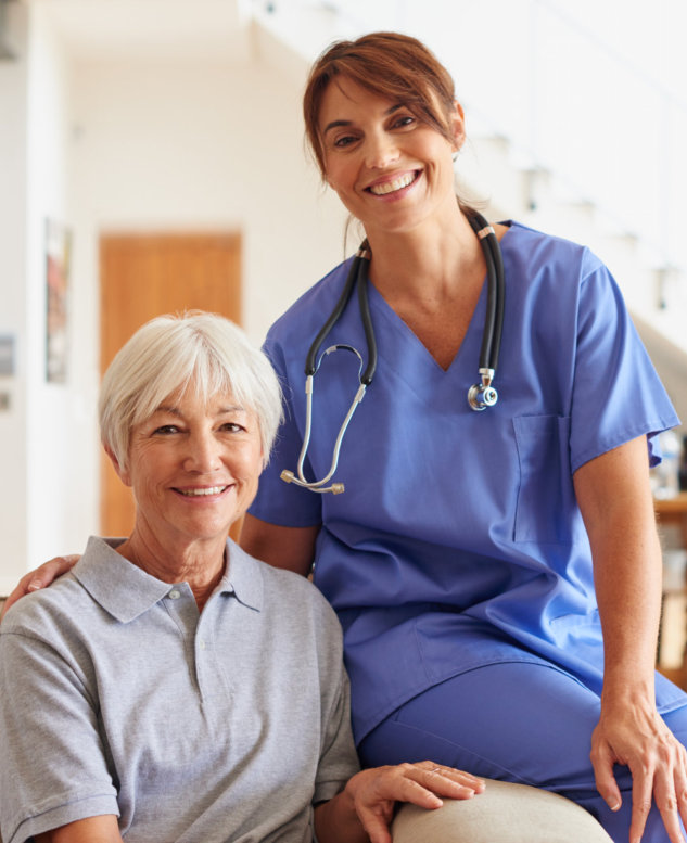 female caregiver and elderly woman smiling