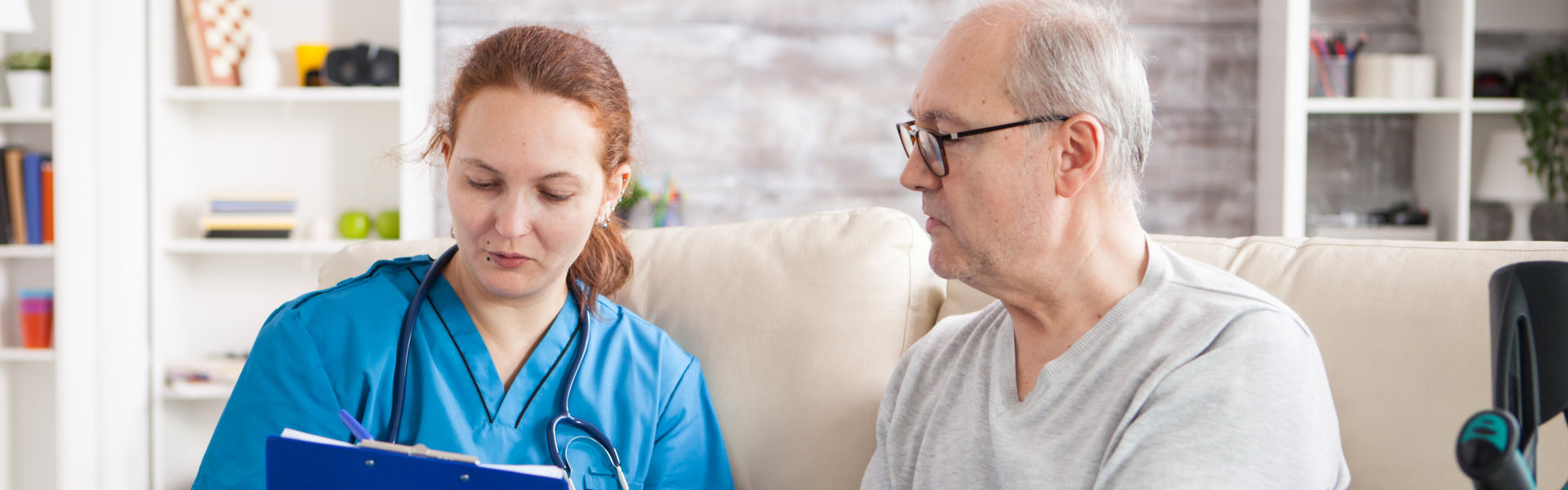 female nurse and elderly man talking