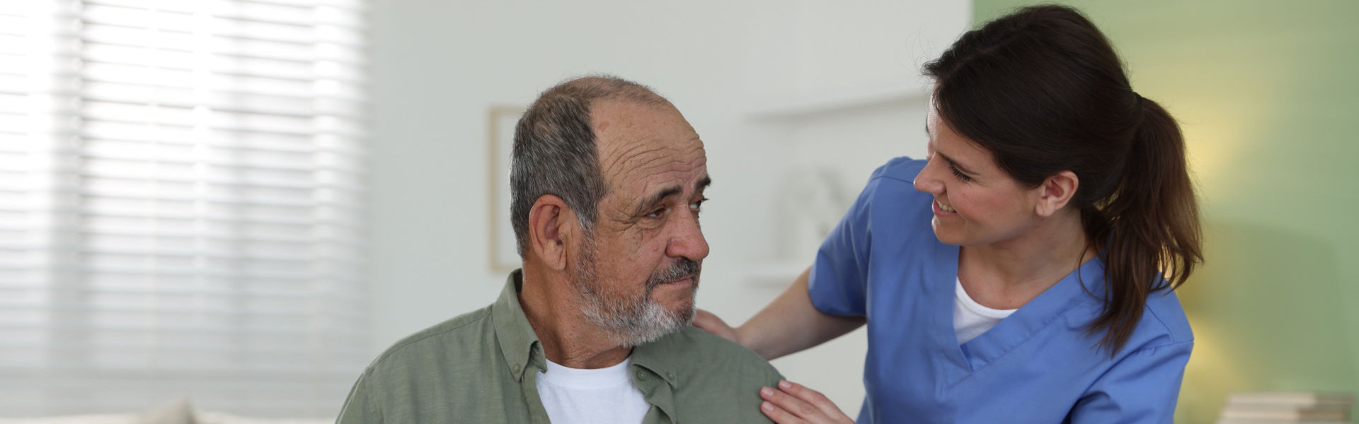 female caregiver taking care of elderly man