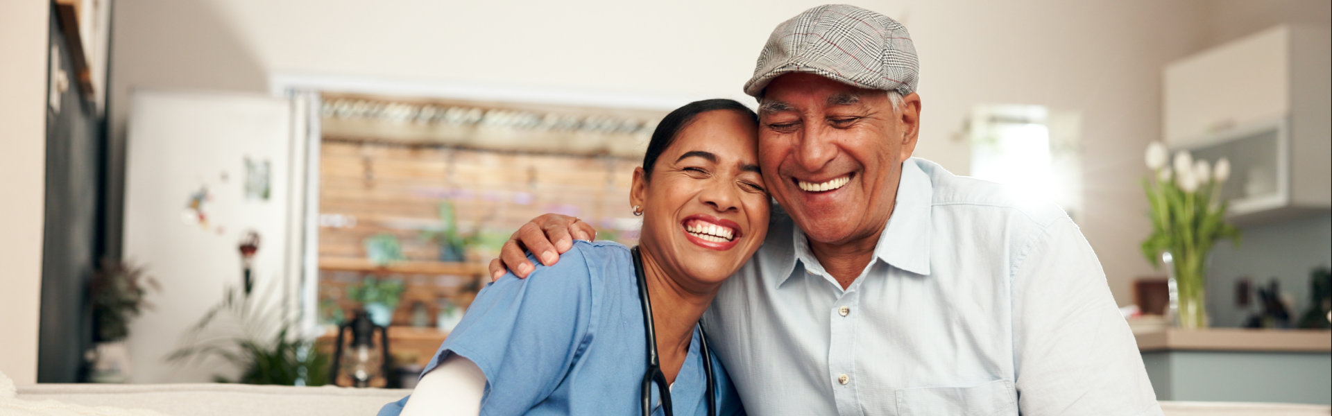 female caregiver and elderly man smiling