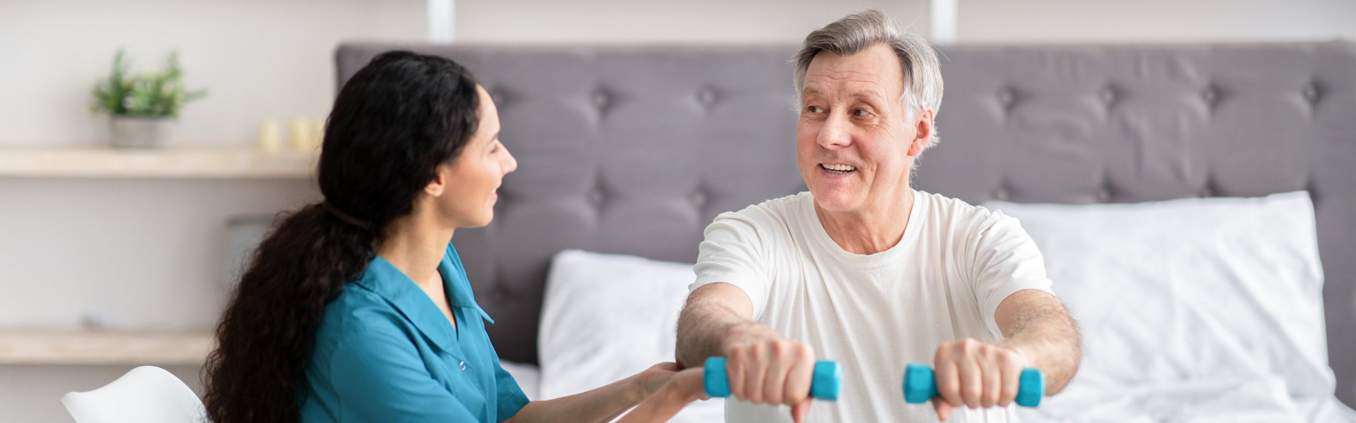 elderly man exercise with female caregiver