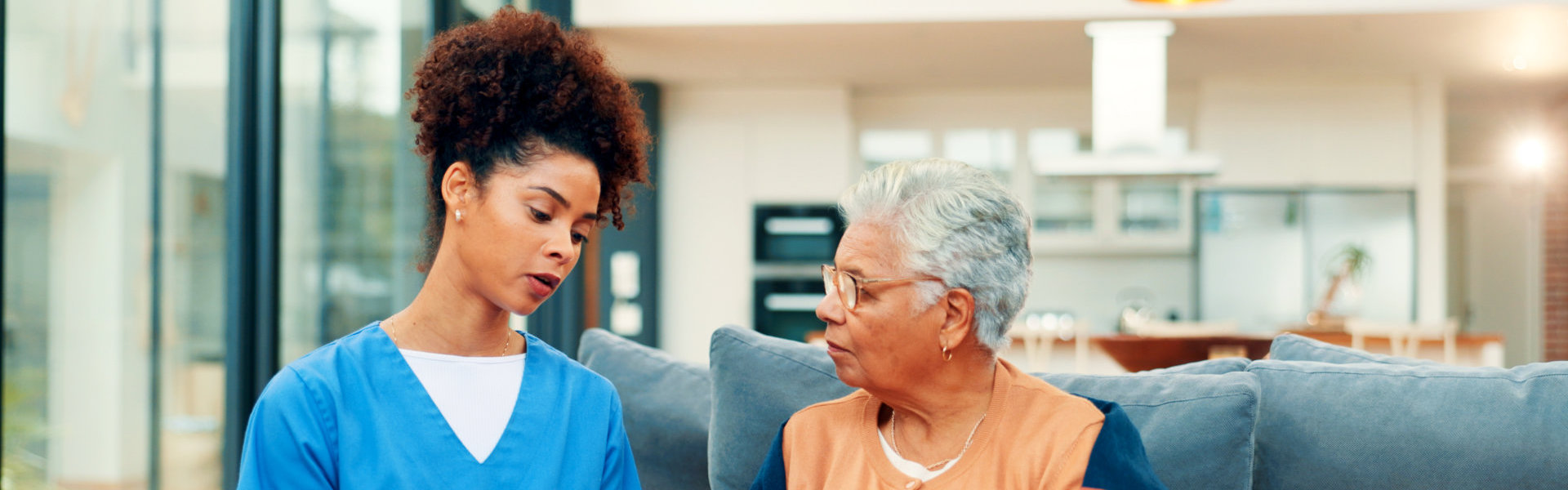 female caregiver and elderly woman talking