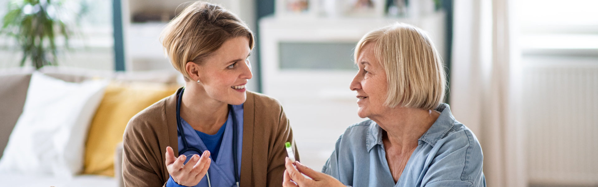 female caregiver and elderly woman talking